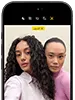 جهاز iPhone&nbsp;18&nbsp;Pro، بلون أسود، الجهة الخارجية الأمامية، عارضتان تتخذان وضعية التصوير أمام الكاميرا، استعراضاً لكاميرا Center&nbsp;Stage الأمامية
