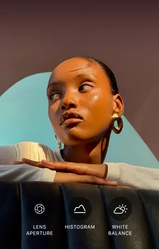 Close up portrait of a well-lit model with a colorful background, demonstrating the pro camera system's Pro controls UI: Aperture, Histogram, White Balance