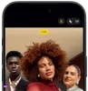 iPhone 18 Pro, black, front exterior, displaying two models posing for the camera, demonstrating the Center Stage front camera